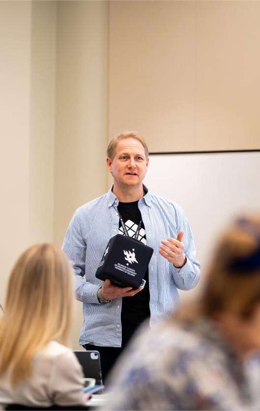 Man presenting in front of other people at a corporate event in Helsinki.