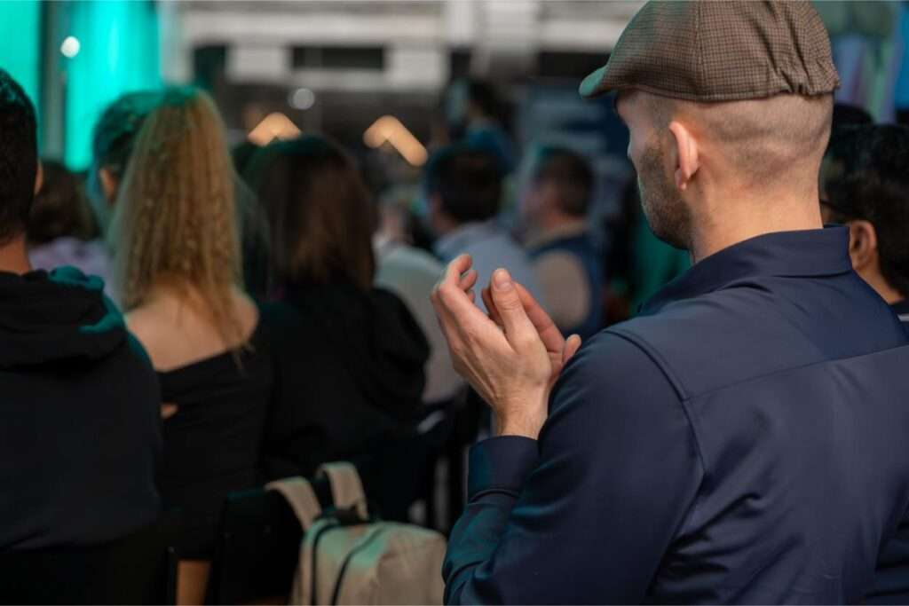 Audience clapping at a live indoor event