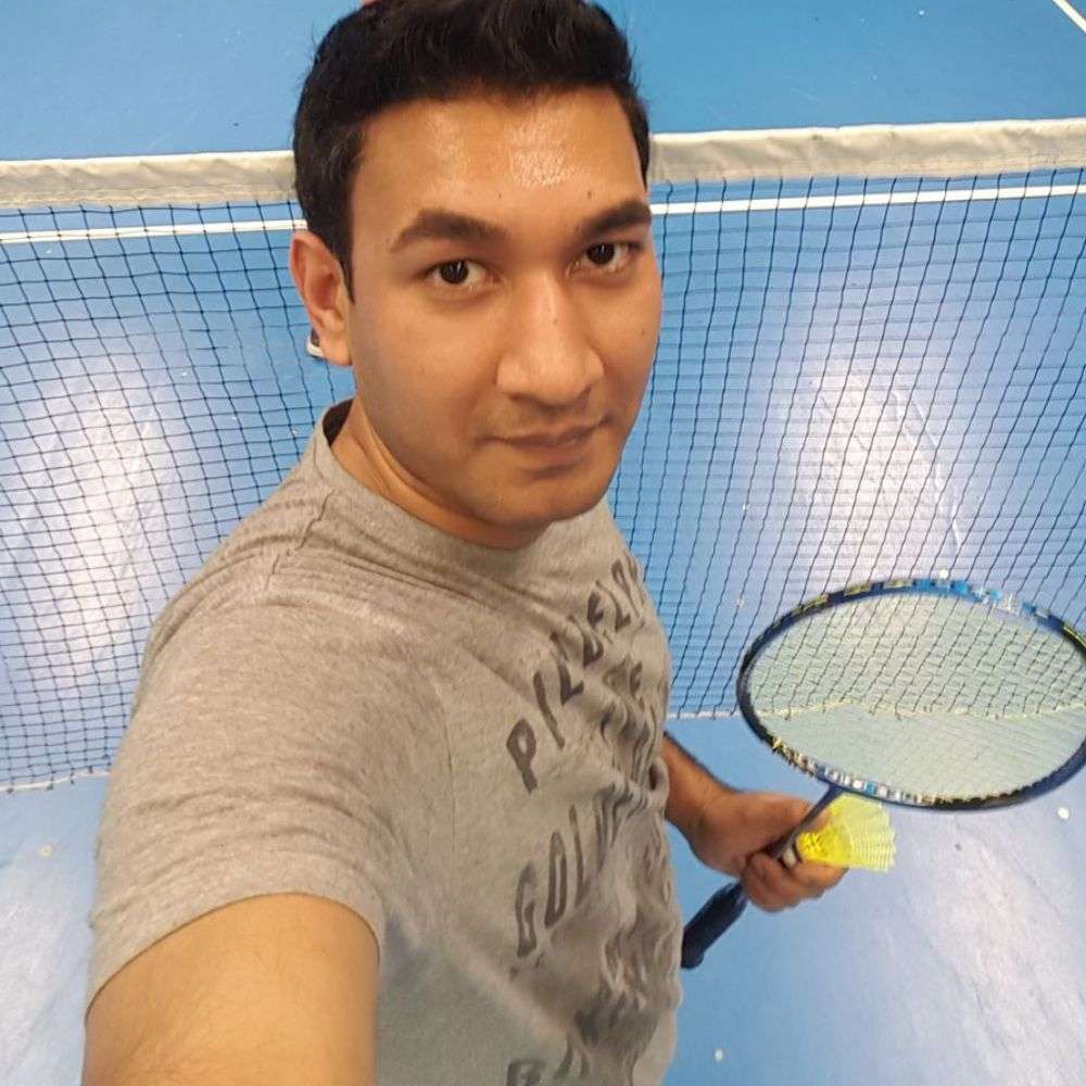 Man taking selfie on indoor badminton court